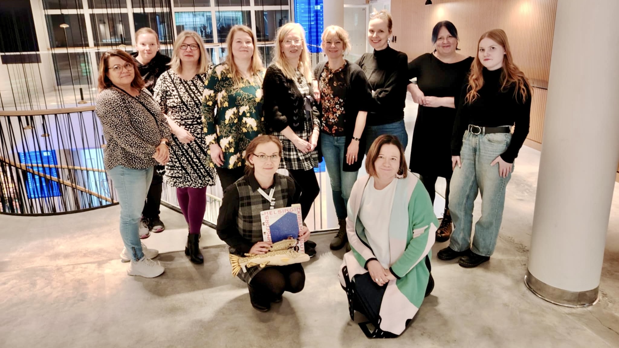 Yhteiskuva, jossa kirjastotyöntekijöitä Helsingin messukeskuksen messusiiven yläaulassa.