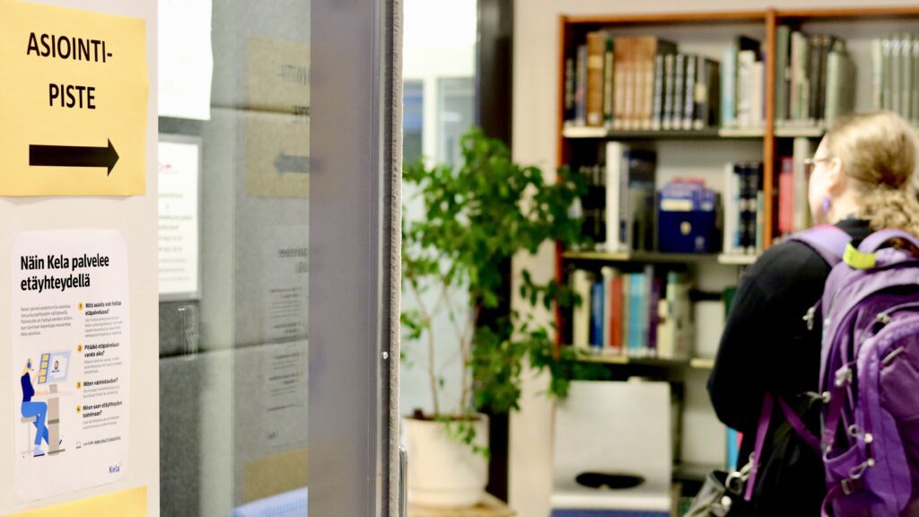 "Asiointipiste"-kyltti kirjaston äänieristetyn neuvottelutilan kyljessä.